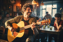 Cheerful Musician Performing In A Pub. Performer Playing A Guitar. People Gathering In The Background.