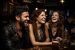 © MNStudio - Group of cheerful friends having fun at dinner party in a pub. Young people having a get together outdoors.