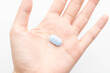 PrEP (Pre-Exposure Prophylaxis) tablet on human hands used to prevent HIV infection.