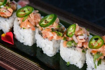 Wall Mural - Appetizing sushi rolls served with salmon in tray