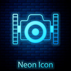 Poster - Glowing neon Photo camera for diver icon isolated on brick wall background. Foto camera icon. Diving underwater equipment. Vector