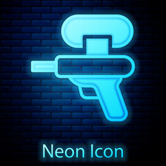 Poster - Glowing neon Water gun icon isolated on brick wall background. Vector