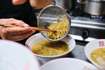 Wall Mural - Crop person cooking ramen in kitchen