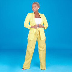 Canvas Print - Corporate, business woman and entrepreneur in studio assertive for career, job and startup on blue background. Professional, fashion and creative young person with confidence, pride and ambition