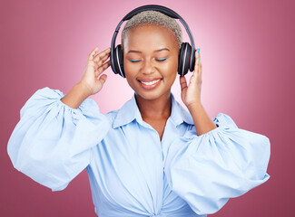 Wall Mural - Music, headphones and happy black woman in studio for radio, streaming or audio subscription on pink background. Podcast, earphones and African lady model smile for album track or feel good playlist