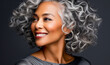© Haydiddle - Beautiful black woman with long, curly gray hair. The elegant lady is smiling and looking to the side