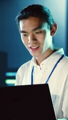 Poster - Vertical video Skillful employee walking through data center systems providing processing resources for different workloads. Admin diagnosing server racks tasked with solving complex operations