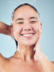 Poster - Skincare, water splash and face of woman cleaning in studio isolated on a blue background. Shower, hygiene and portrait of happy Asian model washing, cosmetic and bath for wellness, health and beauty