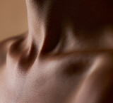 Skincare, beauty and closeup with neck of person in studio for health, textures and cosmetics. Wellness, body and aesthetic with zoom of woman on brown background for glow dermatology and glamour