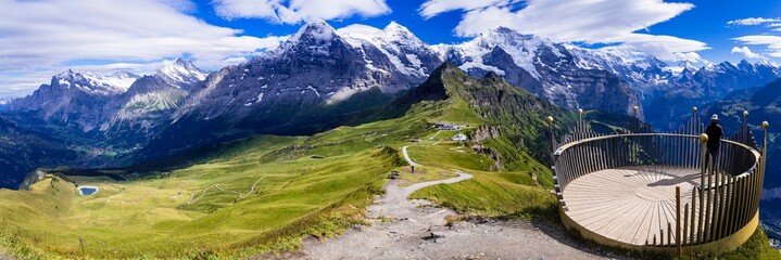 Poster - Swiss nature scenery. Scenic snowy Alps mountains and wild floral meadows. Beauty in nature. Switzerland landscape. View of Mannlichen mountain and famous hiking route Royal road