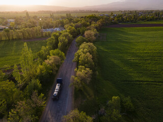 Wall Mural - Gasoline truck Oil trailer on highway driving along the road. aerial view of Tank vehicle at work