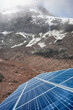 Close up photo of solar panels with Chimborazo volcano in background, selective focus, Ecuador.
