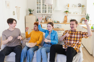 Wall Mural - Group of friends watching sport match soccer football game on tv. Happy football fans celebrating victory at home. Friendship sports entertainment concept. Diverse buddies having fun together at home