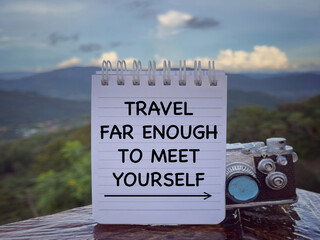 Wall Mural - Motivational and inspirational wording. Travel Far Enough To Find Yourself written on a notepad. With blurred styled background.
