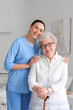 © Pixel-Shot - Young caregiver with senior woman in bedroom