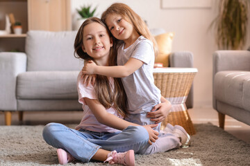 Wall Mural - Cute little sisters hugging at home