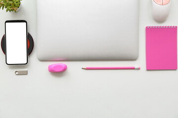 Poster - Laptop with wireless charger pad, phone and stationery on white background