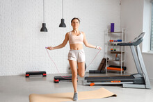 Sporty Young Woman With Jumping Rope Training In Gym