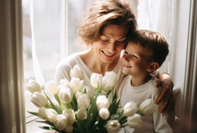 Gentle Mother-Son Hug In The Comfort Of Home With White Tulip Bouquets