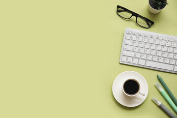 Wall Mural - Keyboard, cup of coffee and stationery on light green background