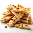 © Elle Arden  - Pieces of delicious peanut brittle with a white background. Generative AI.