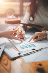 Group of business people analysis summary graph reports of business operating expenses and work data about the company's financial statements.