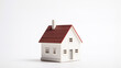 © piggu - miniature house on white background. saving money and property investment concept