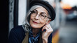 © PaulShlykov - Hipster senior woman wearing glasses and fashionable hat outdoors portrait