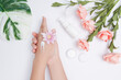 Moisturizing care skincare face cream for healing complicated troubled skin type. girl smears her hands cosmetic cream. skin care, elastic and young skin of the hands. flat lay, top view.