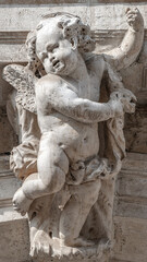 Canvas Print - Venice, Italy - Portrait with a ancient wall decoration sculpture of a beautiful angel as a child with wings in historical downtown of Venice