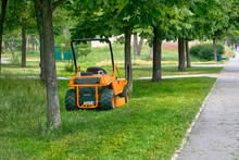 Professional Grass Cutting On Lawns With A Mini Tractor Lawn Mower.