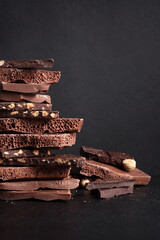 Wall Mural - Various chocolate pieces on dark background