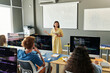 © Mediaphotos - Teacher explaining material to students during IT lesson in the classroom
