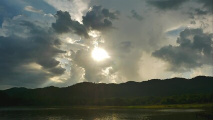 Wall Mural - Time-lapse of Clouds fast in the sky and sunset on a large natural or artificial lake used as a source of water supply.