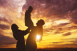 © Creativa Images - Silhouette of Happy arabian family playing together over sunset