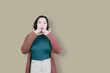 © Creativa Images - Image of shocked asian woman in panic isolated over brown background