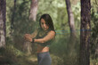 © ADDICTIVE STOCK CORE - Fit ethnic woman doing exercises with elastic band