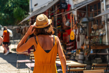 Wall Mural - A woman tourist visiting the city of Gjirokaster or Gjirokastra. Albanian