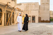 © oneinchpunch - Middle eastern couple of lovers wearing traditional emirati clothing dating outdoors in Dubai - Modern arabian couple meeting and having fun in the city