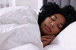 © New Africa - Beautiful young woman sleeping in soft bed