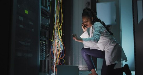 Sticker - Animation of data processing over african american female engineer using laptop at server room