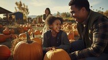 Father, Daughter, And Mother Enjoying An Autumn Day At A Pumpkin Patch