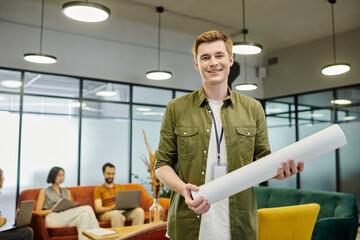 Wall Mural - positive entrepreneur with blueprint looking at camera and blurred partners talking in office space