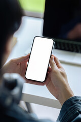 Mockup image of a man holding and using mobile phone with blank desktop screen