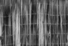 Black And White Abstract Of Wire Fence In Front Of Wooden Fence Abstract Blur Up And Down Vertical Movement Created By Slow Shutter Speed And In Camera Movement Creating Blurry Streaks  Backdrop 