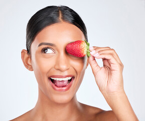 Sticker - Health, smile and woman with a strawberry in studio for healthy diet snack for nutrition. Wellness, beauty and young Indian female model with fruit for natural skin detox routine by white background.