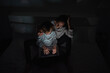 © ADDICTIVE STOCK CORE - Mother helping son to do homework in darkness