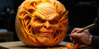 Top view shot of male hands carving creative human face shaped jack-o-lantern with hair Funny halloween pumpkin being carved by unrecognizable man. Close up, copy space, black background
