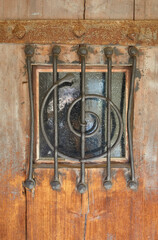 Wall Mural - Artfully barred window on a castle gate.