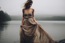 Beautiful Young Woman In A Dress Against The Backdrop Of A Misty Lake